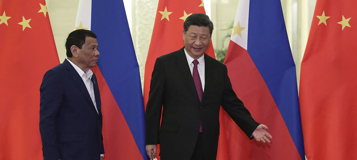 Philippine President Rodrigo Duterte (L) is shown the way by Chinese President Xi Jinping before their meeting at the Great Hall of People in Beijing