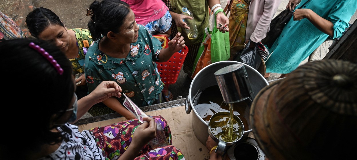 People queue to buy cheap vegetable oil, in Yangon on August 18, 2022.