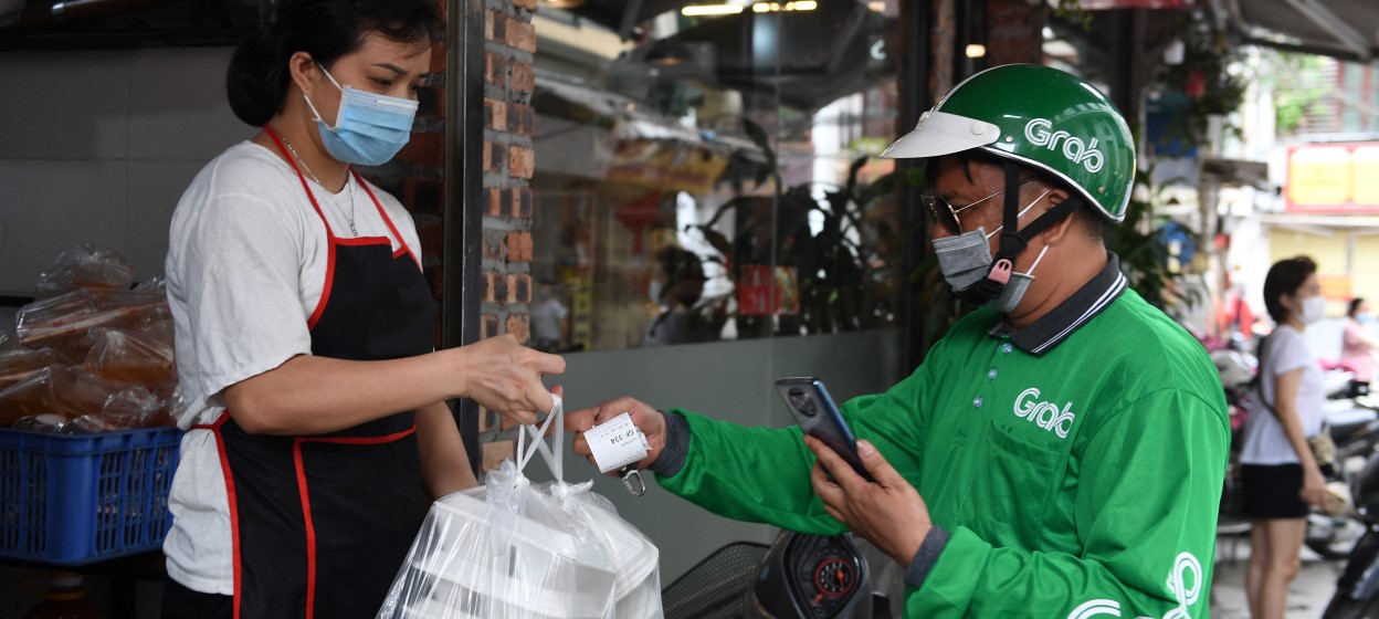 A Grab delivery service personnel receives a take away food order