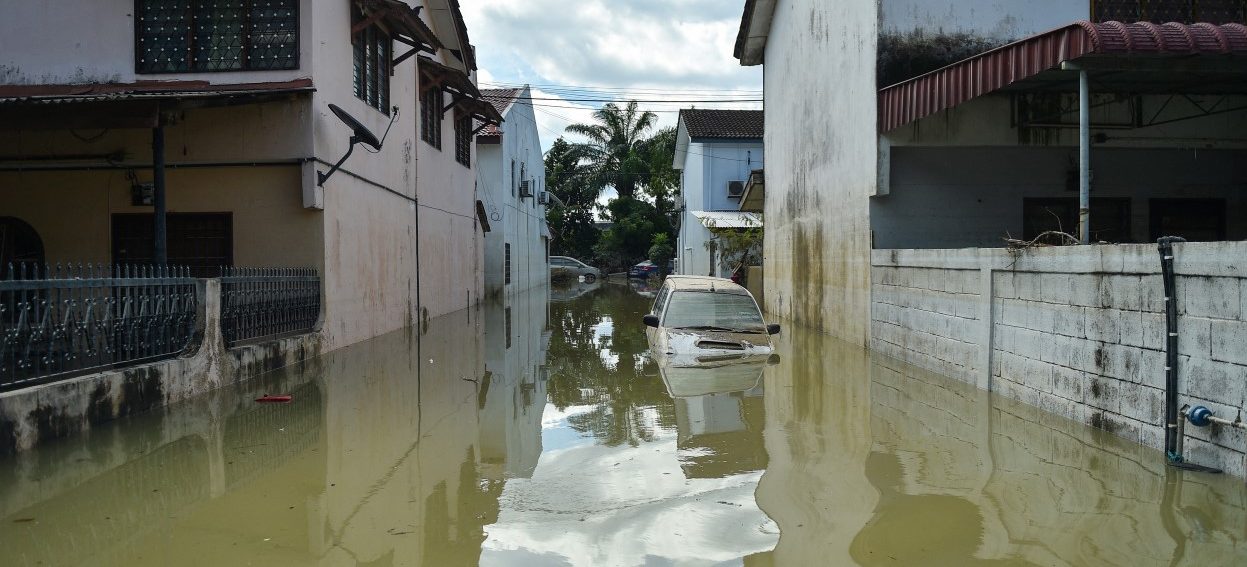 A car is seen partially submerged in floodwaters in Shah Alam, Selangor on December 21, 2021, as Malaysia faces massive floods that have left at least 14 dead and more than 70,000 displaced. (Photo: Arif KARTONO / AFP)