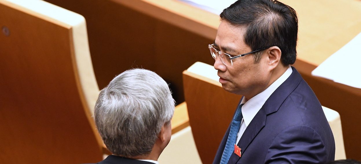 Pham Minh Chinh (C), then Politburo member and Head of the Central Organizing Committee of the Vietnam Communist Party, chats with a deleguate prior to the opening of the second annual session of the National Assembly in Hanoi, October 2017. Pham has been elected as the new Prime Minister during the CPV’s recent 13th National Congress in Hanoi. (Photo: Hoang Dinh NAM / AFP)