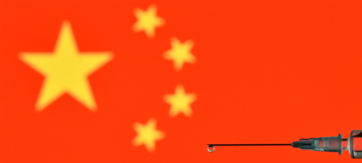 An illustration picture shows a drop from a syringe with a flag of China reflected in it