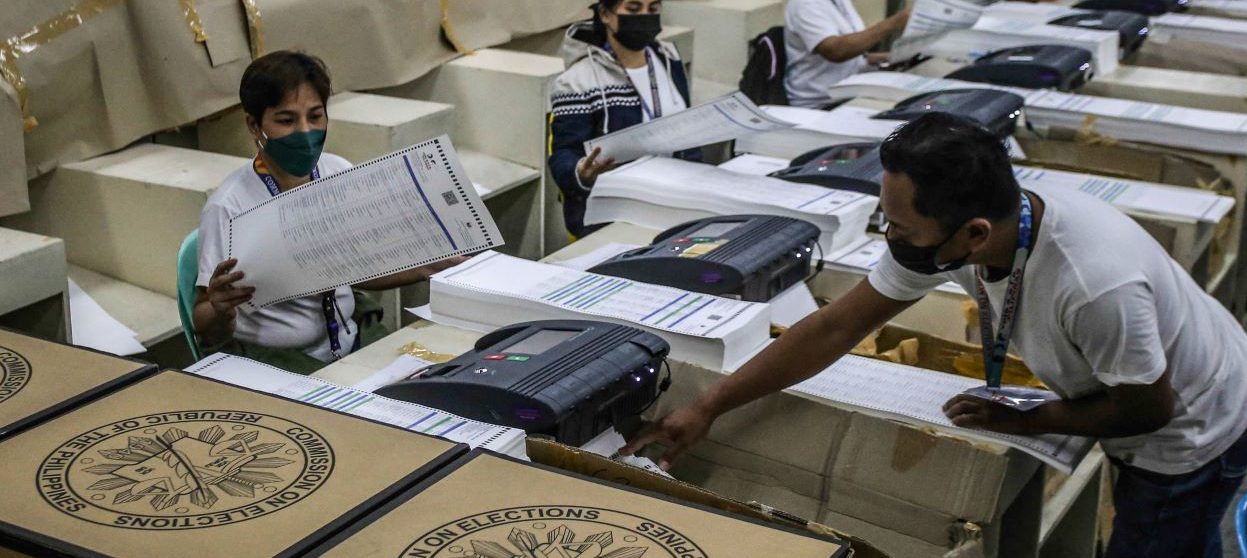 Workers verify printed ballots for Philippine elections