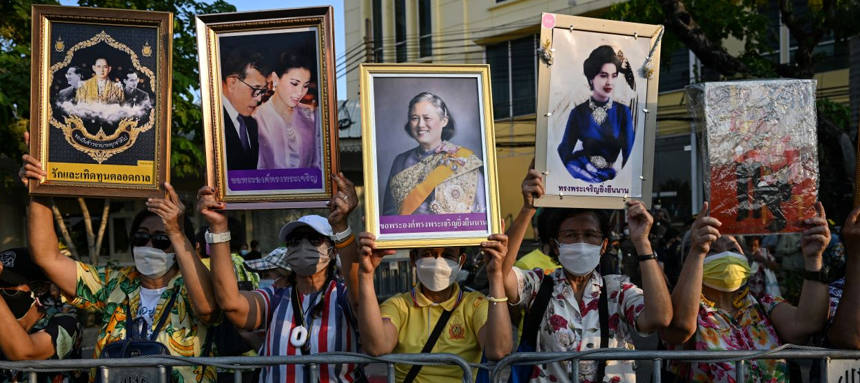 Royalist protesters hold images of the Thai royal family during a rally to support the Thai monarchy